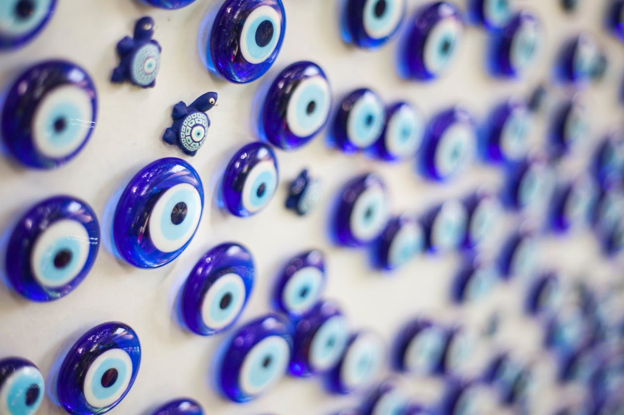 Vibrant blue glass evil eye charms on display as a protective symbol and decorative item.