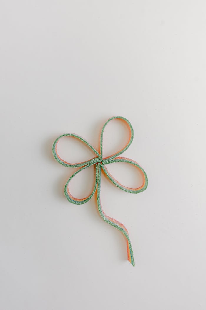 Creative clover-shaped ribbon on a neutral background, perfect for St. Patricks Day themes.